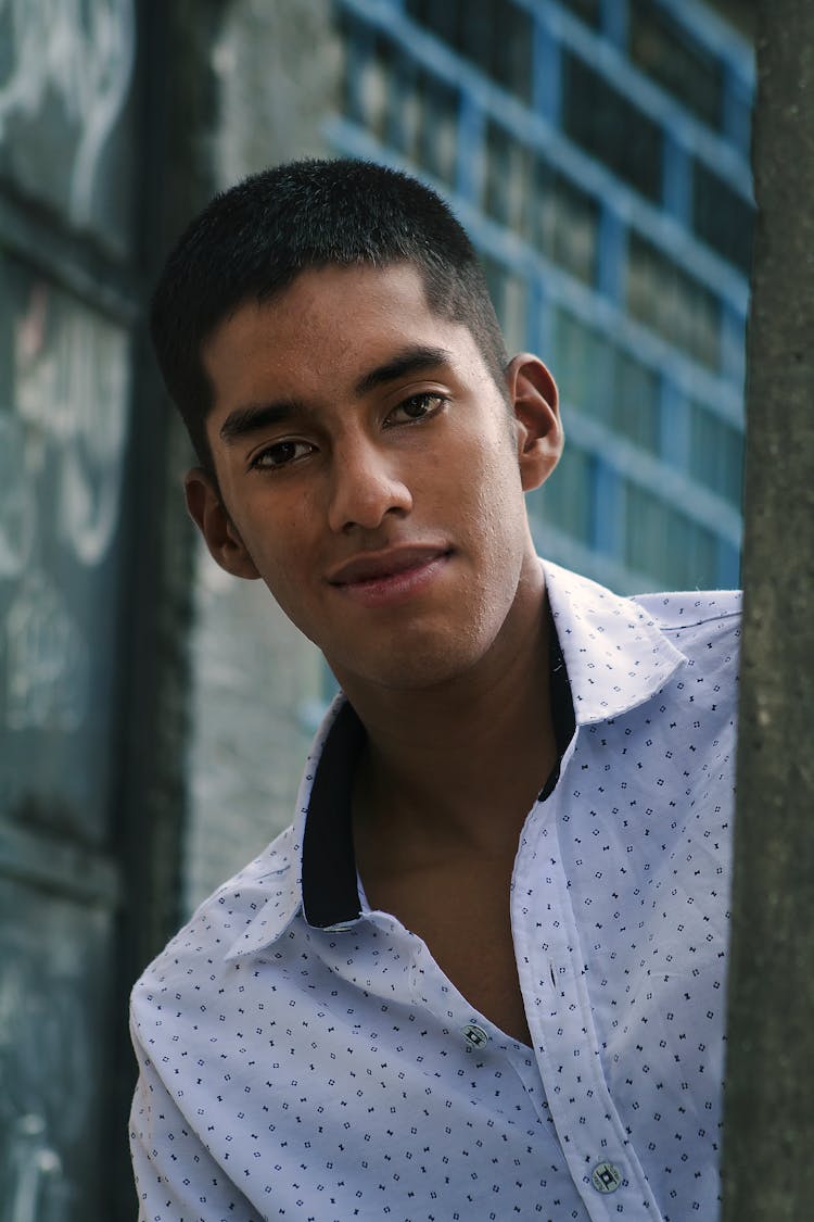 Smiling Man In White And Black Polka Dot Button Up Shirt