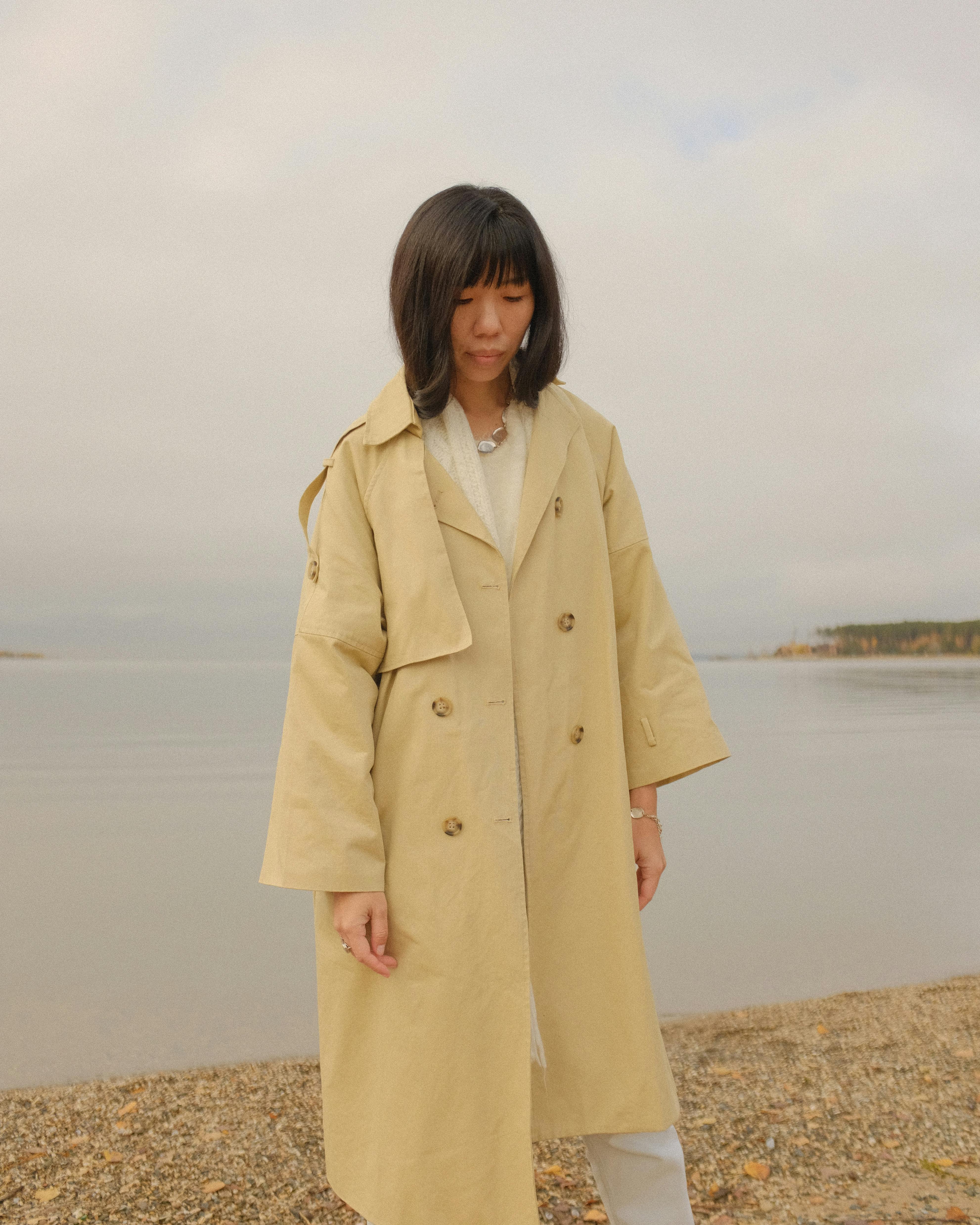 Woman Wearing Beige Coat Looking Down · Free Stock Photo