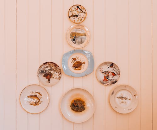 White Ceramic Plates Hanging on a White Wooden Wall