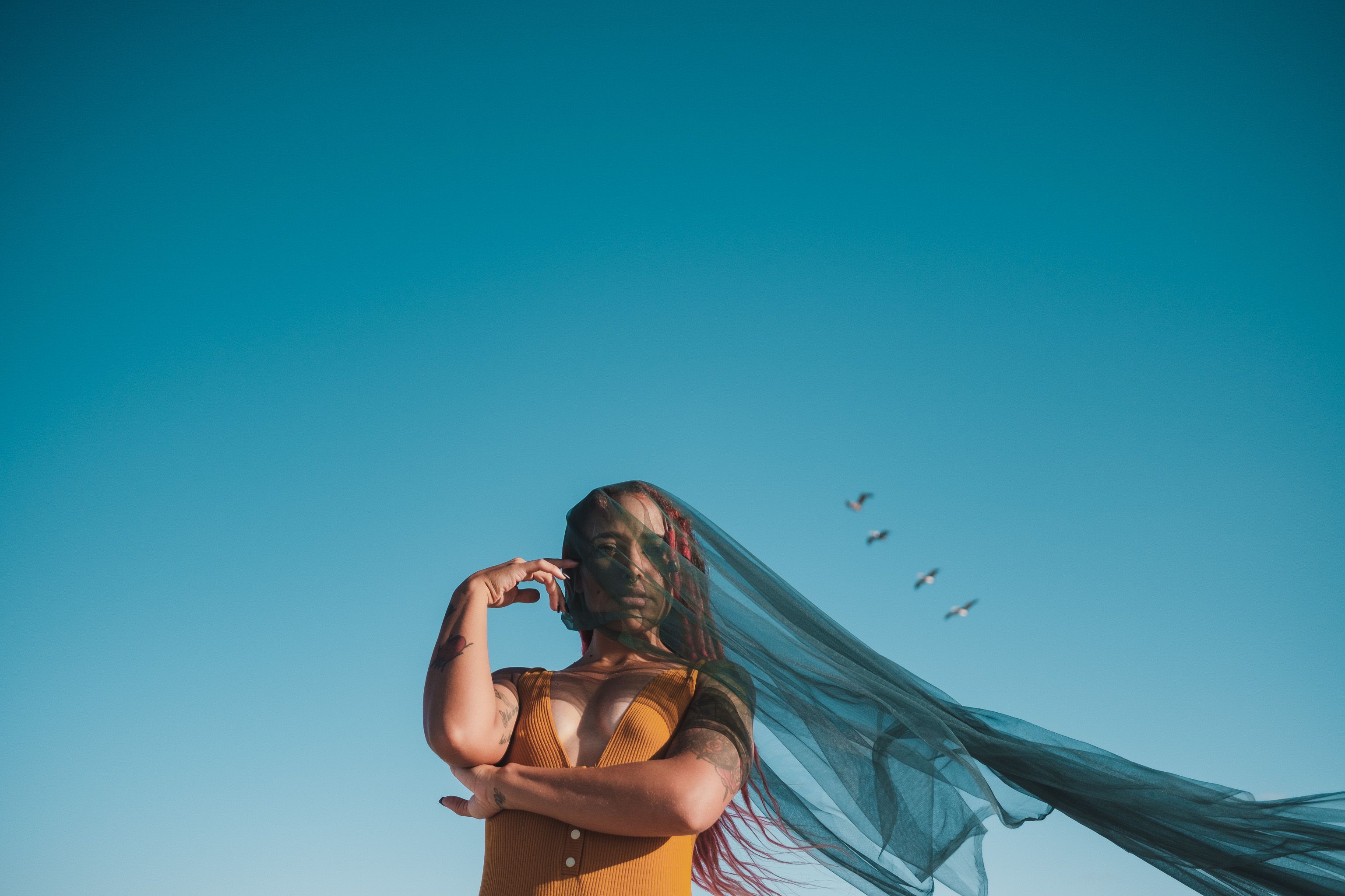 Young Woman in a Dress Posing on a Field · Free Stock Photo
