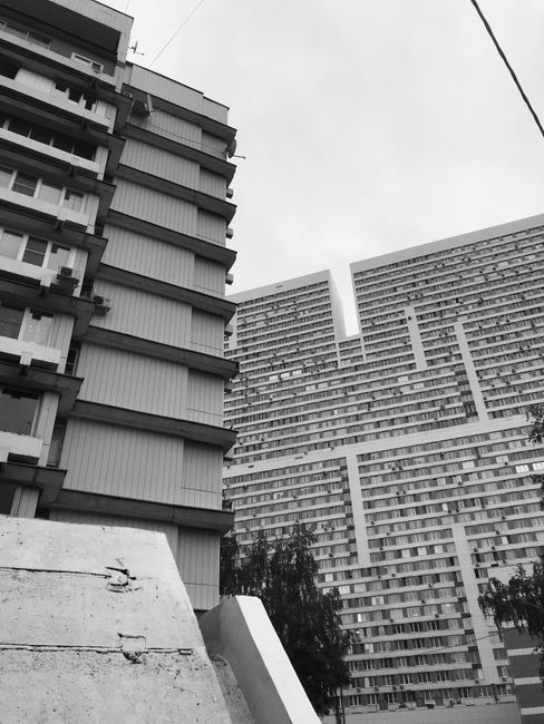 Black and white photo of modern residential skyscrapers capturing abstract architectural lines.