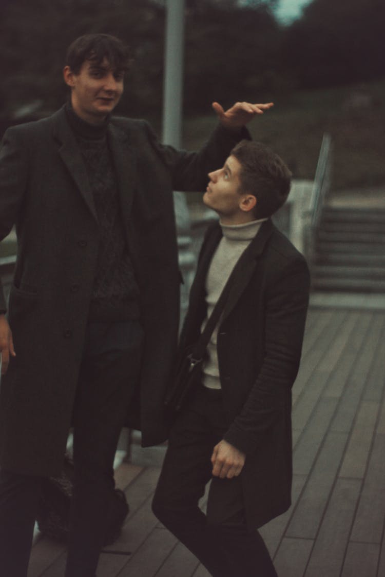 Two Men Standing On A Pier 