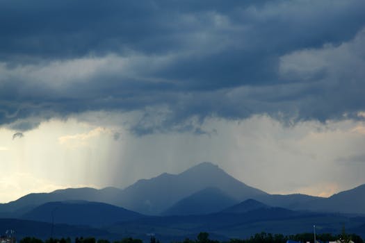 Dark storm clouds loom over mountains in Liptovský Mikuláš, Slovakia, capturing nature's power.