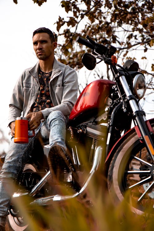 Man in Gray Jacket Riding on Red Motorcycle