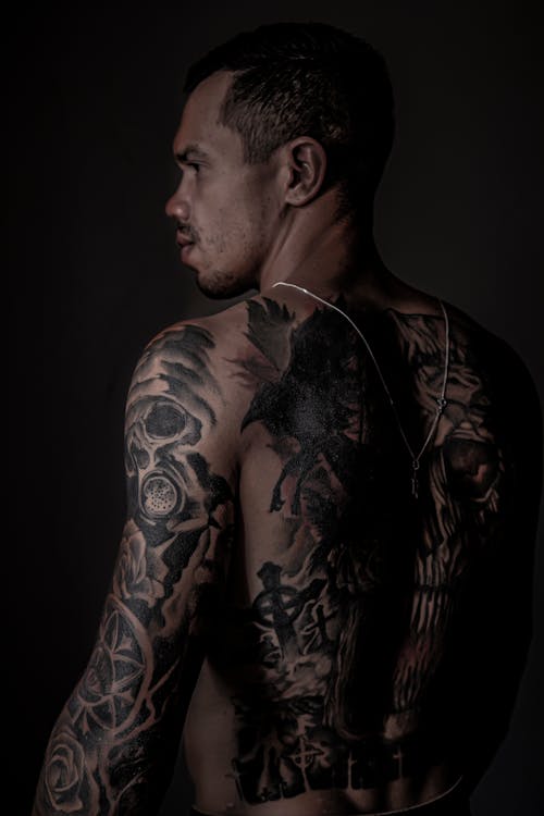 Shirtless Man with Tattoo on His Back and Arms