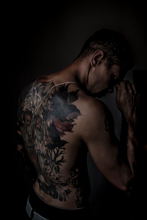 Topless Man with Tattoo on His Back