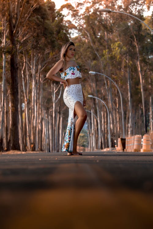 A Woman in Tube Top Standing on the Road