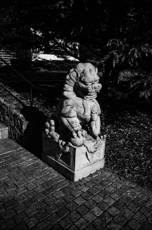 Grayscale Photo of a Lion Sculpture