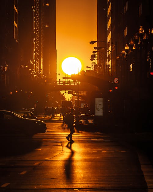 Free Silhouette of Person Walking on Road During Sunset  Stock Photo