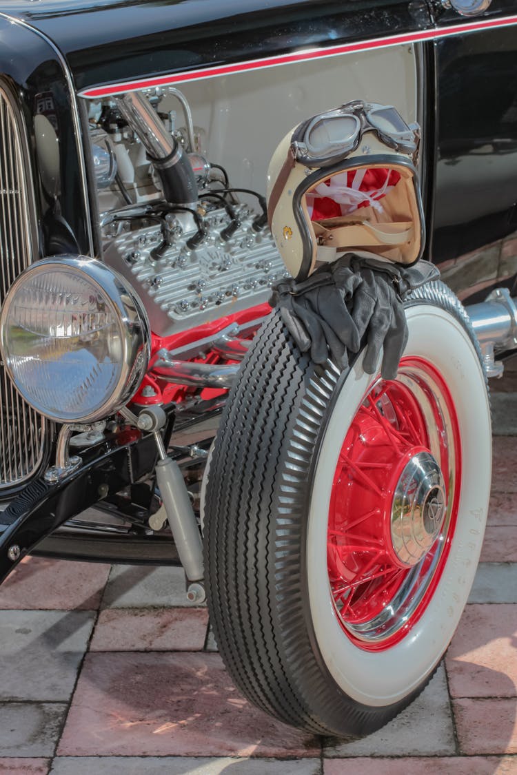 Helmet And Gloves On Tyre Of Vintage Racing Car