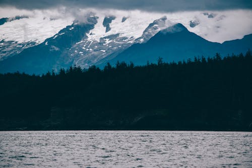 A Snow Covered Mountain Near Body of Water