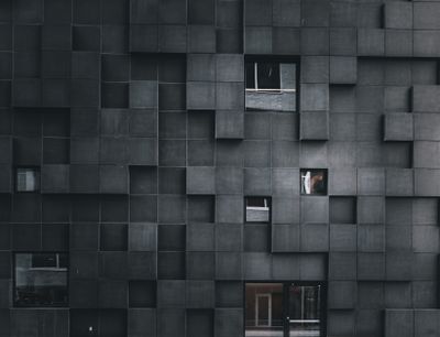 Modern architectural facade with geometric patterns and scattered wind — Photo by Nur  Yilmaz on Pexels
