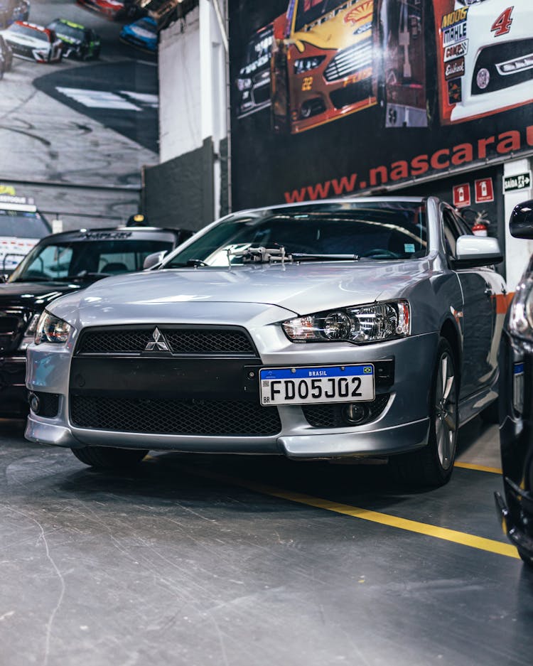 Gray Mitsubishi Lancer Car On Auto Show 