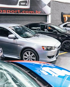 A sleek display of modern vehicles in a well-lit showroom, highlighting automotive design.