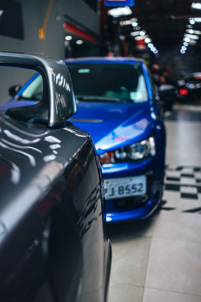Dynamic shot of racing cars in a showroom, highlighting speed and style.