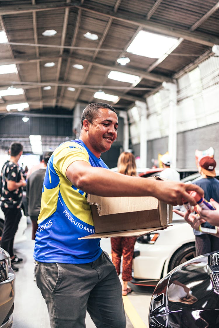 Man Carrying Cardboard Box