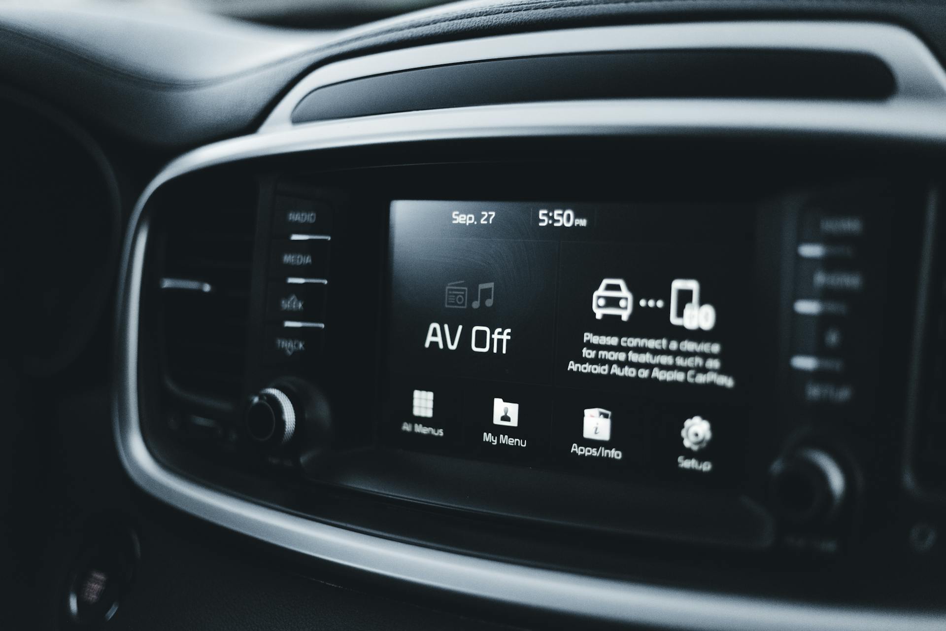 Detailed close-up of a modern car dashboard screen displaying various tech options and settings.