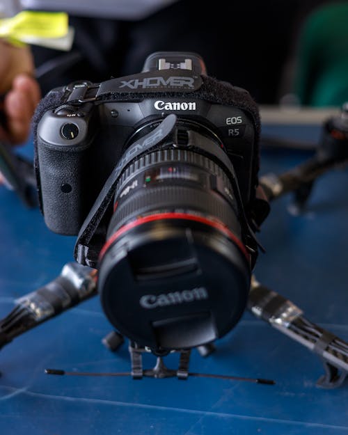 Free Black Canon Dslr Camera on Blue Surface Stock Photo
