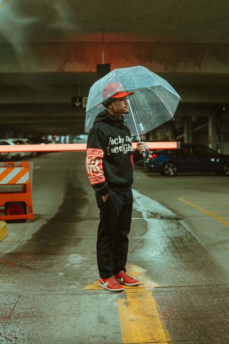 Man Holding Umbrella, Standing On Parking