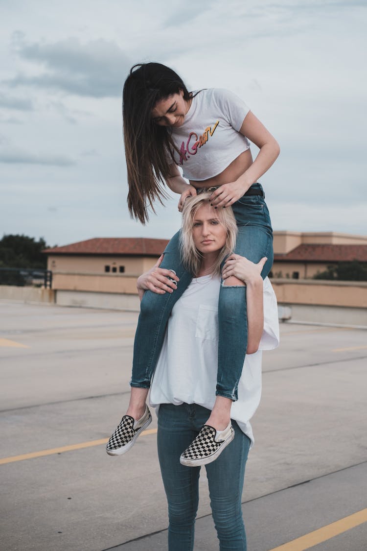 A Couple In White Shirts And Denim Pants 