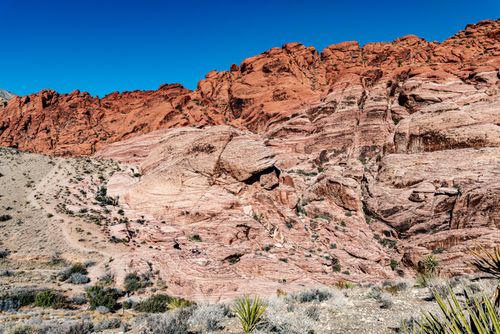 Free A breathtaking view of Red Rock Canyon's layered rock formations under a clear blue sky. Stock Photo