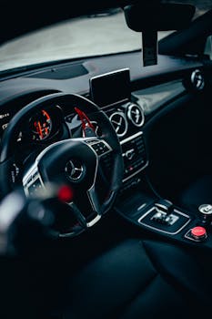 Close-up of a luxury car interior focusing on the dashboard and controls.