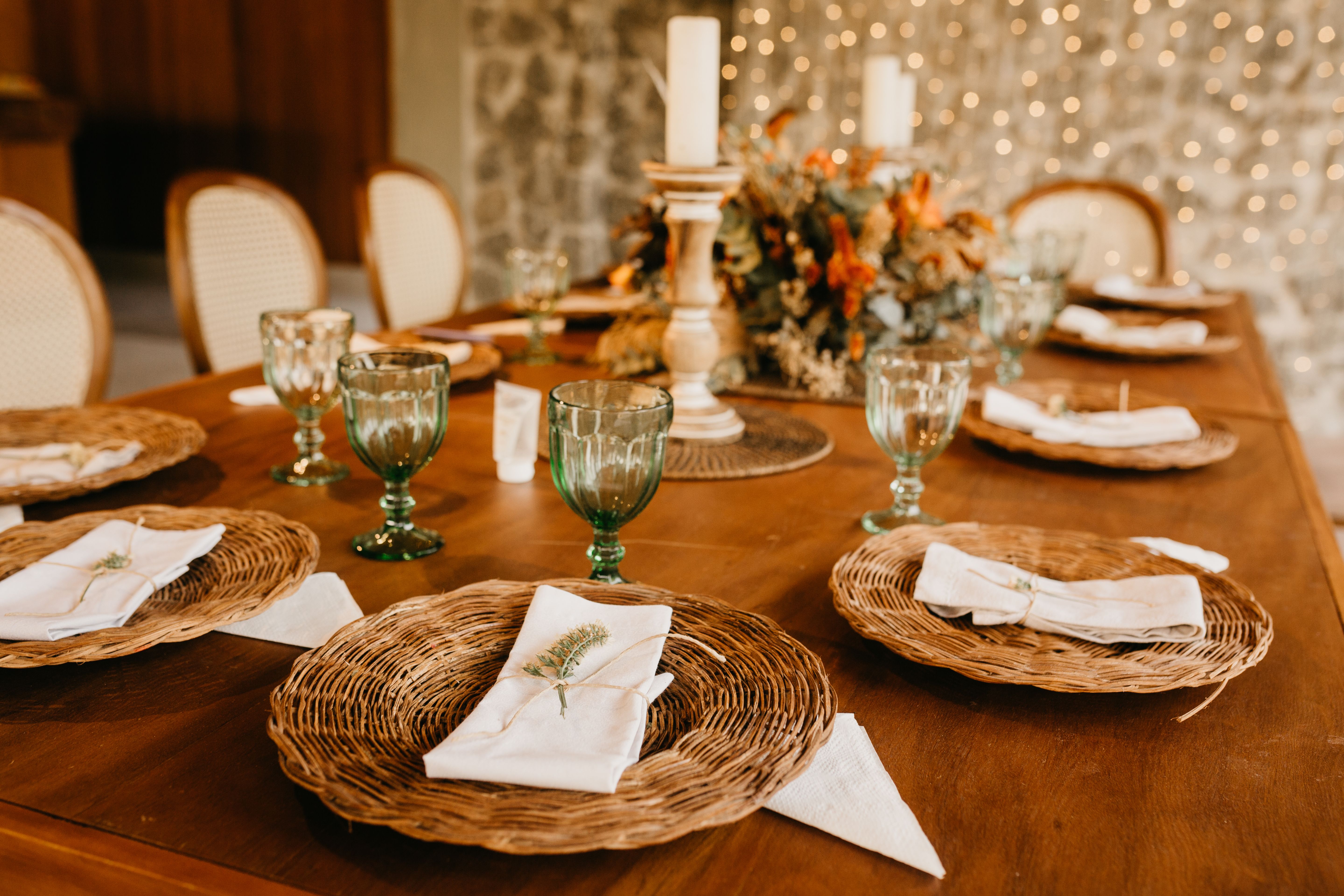 Beautiful rustic table setting with decorative plates and glassware at a wedding reception.