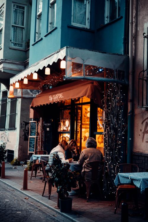 Free Charming street café in Istanbul, Türkiye, with people enjoying a cozy evening outdoors. Stock Photo