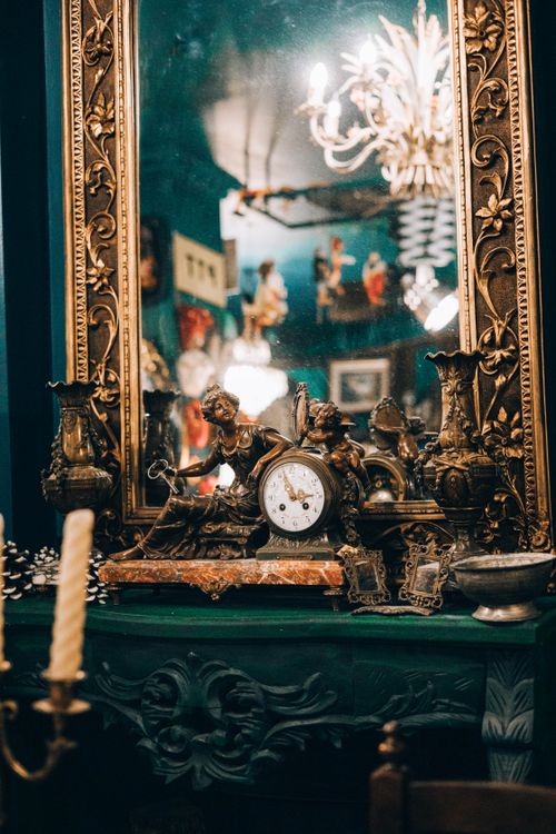 Free Elegant vintage clock and ornate mirror with classical decorations on a desk. Stock Photo