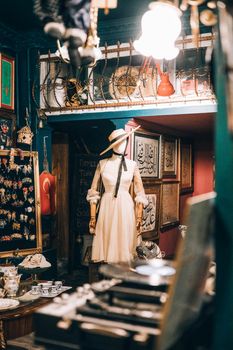A stylish vintage clothing store interior featuring a mannequin dressed in classic attire.