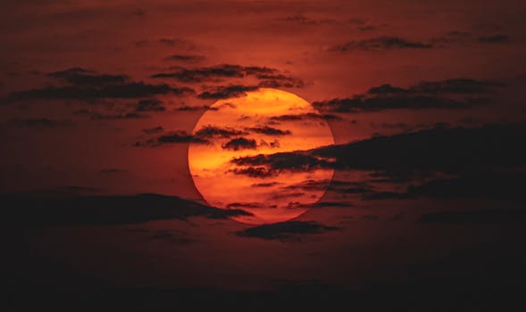 Stunning sunset with vibrant orange hues and dramatic clouds over Dubai.