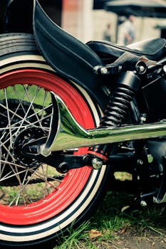 这辆复古摩托车细节尽显，鲜红的钢圈和镀铬排气管格外醒目