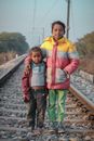 2 Women Standing on Train Rail