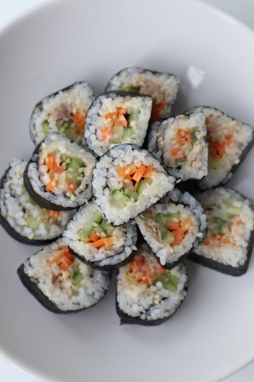 Yummy salmon and cucumber sushi rolls served on plate