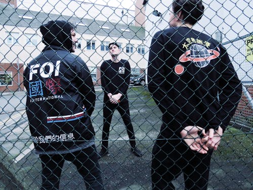 Free stock photo of boys, chain link fence, fashion