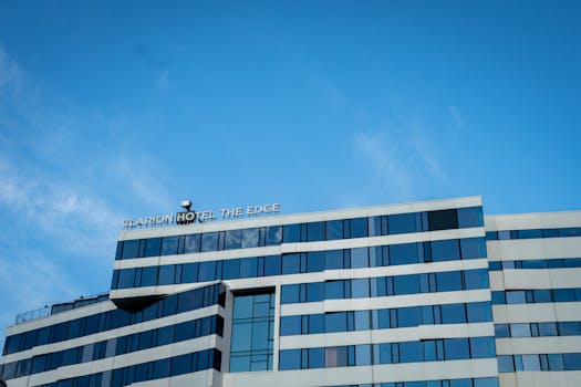 Modern hotel architecture against a blue sky in Tromsø, Norway.
