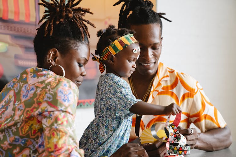 Couple Making An Artwork With Their Daughter