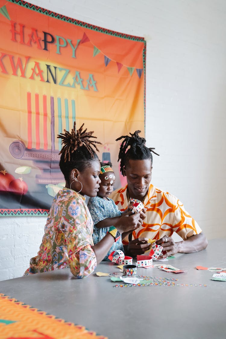 Couple Making An Artwork With Their Daughter