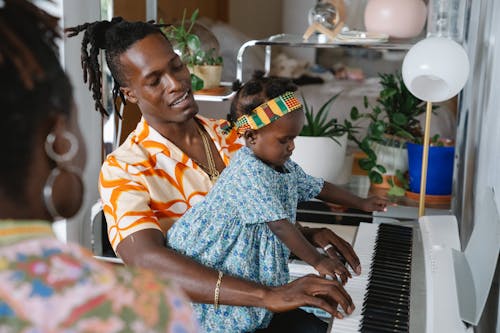 Free Dad and Daughter Playing the Piano Together Stock Photo