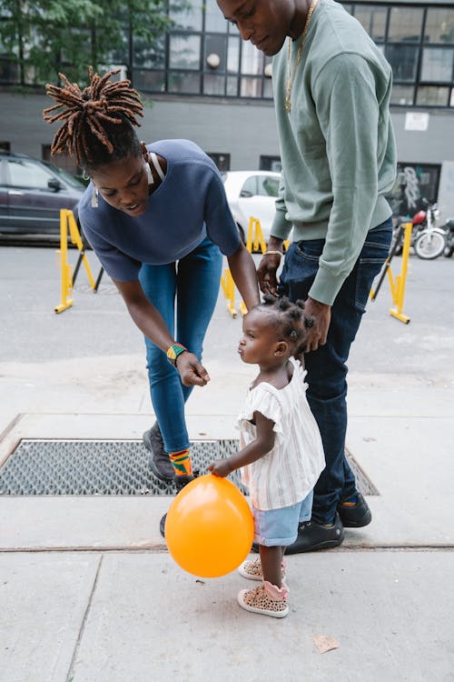 Couple Walking with Their Daughter Outside