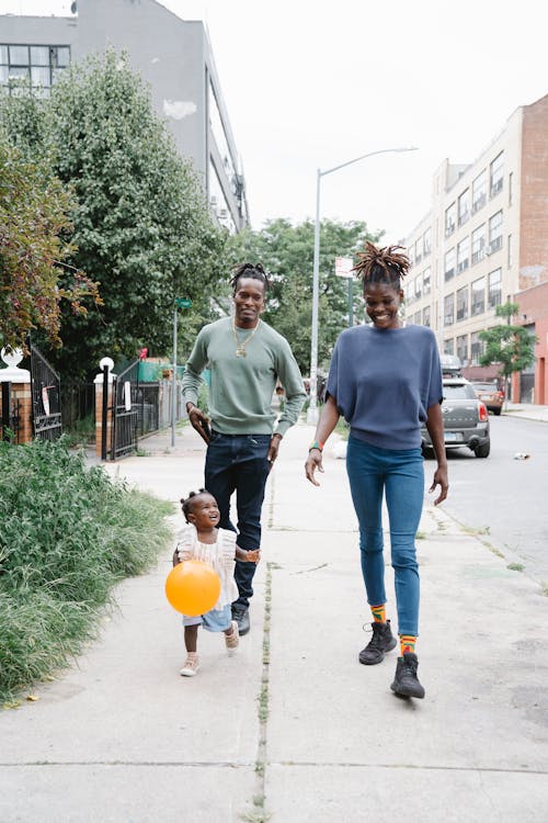 Couple Walking with Their Daughter Outside