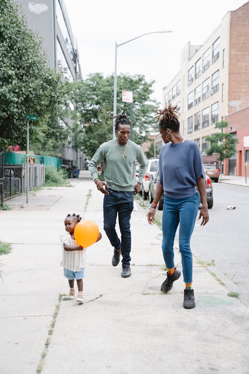 Couple Walking with Their Daughter Outside