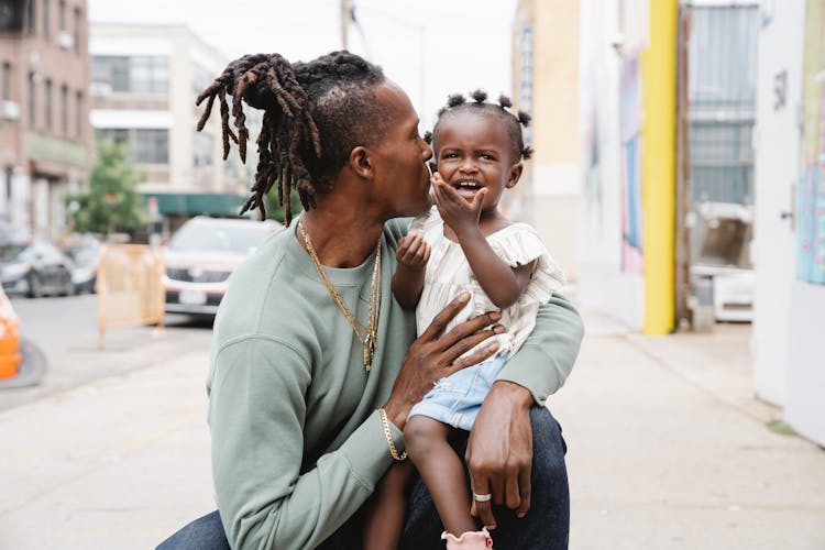 A Dad Kissing His Cute Daughter