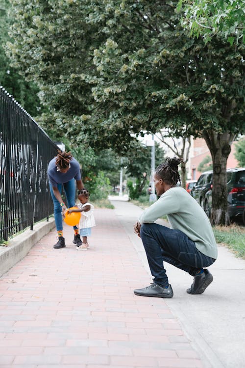 Couple Walking with Their Daughter Outside