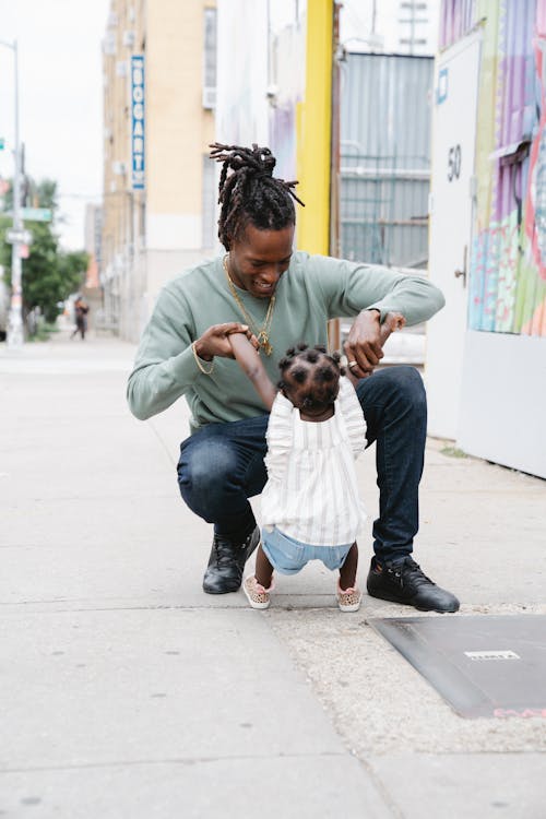 Father playing with his daughter on the street