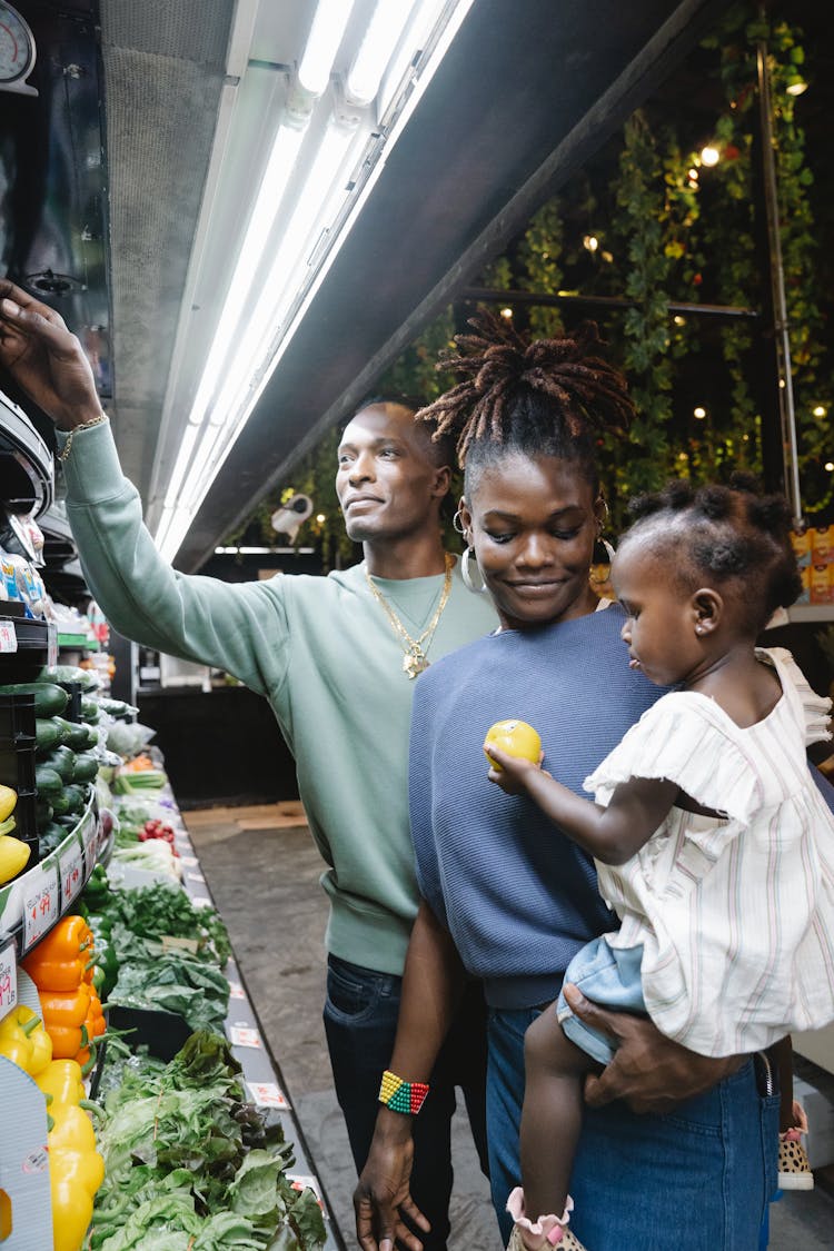 A Family Buying Groceries In A Supermarket