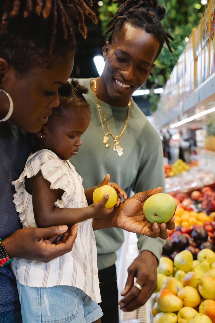 A Family Buying Groceries In A Supermarket