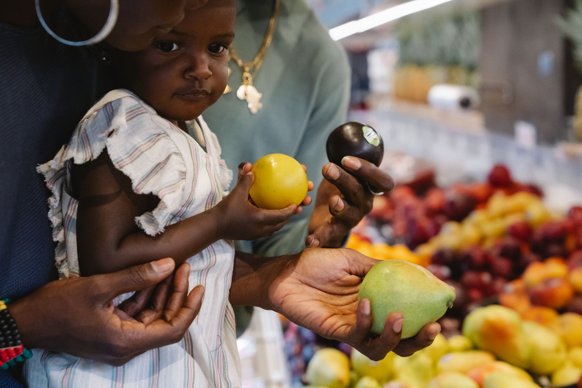 Girl in grocery store holding fruits