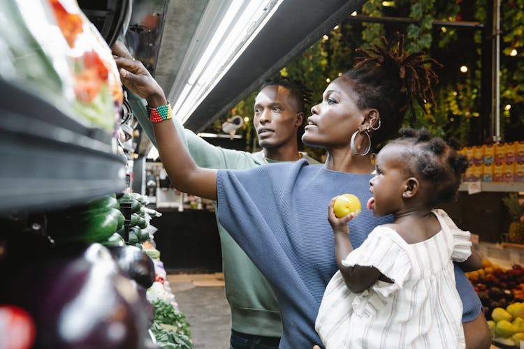 A Family Buying Groceries In A Supermarket