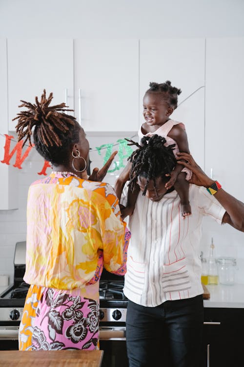 A Happy Family Playing with Their Daughter